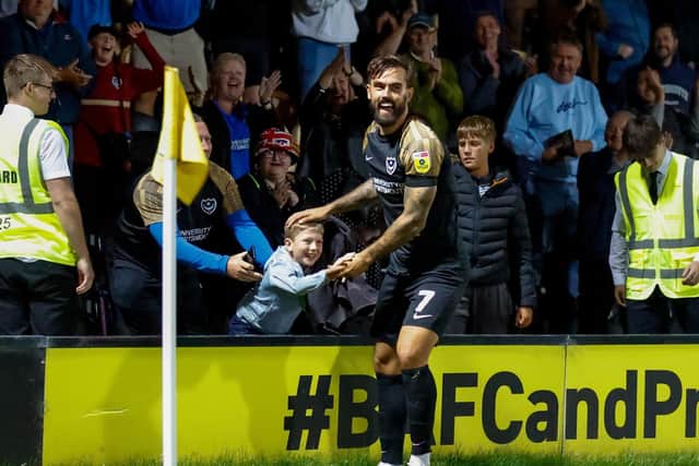 Marlon Pack celebrates with Oscar Woodley after he played a vital role in Pompey's opener at Burton.