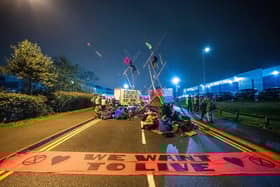A handout picture released by Extinction Rebellion on September 5, 2020, shows Extinction Rebellion activists blocking the entrance to the News Corporation newpaper printers at Broxbourne, north of London on September 4, 2020, "to expose the failure of these corporations to accurately report on the climate and ecological emergency". Climate change protesters in Britain blockaded two newspaper printing sites early Saturday, disrupting the distribution of titles including The Times, the Daily Telegraph and The Sun. Credit: TOM OLDHAM/Extinction Rebellion/AFP via Getty Images.