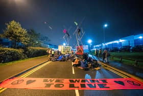 A handout picture released by Extinction Rebellion on September 5, 2020, shows Extinction Rebellion activists blocking the entrance to the News Corporation newpaper printers at Broxbourne, north of London on September 4, 2020, "to expose the failure of these corporations to accurately report on the climate and ecological emergency". Climate change protesters in Britain blockaded two newspaper printing sites early Saturday, disrupting the distribution of titles including The Times, the Daily Telegraph and The Sun. Credit: TOM OLDHAM/Extinction Rebellion/AFP via Getty Images.