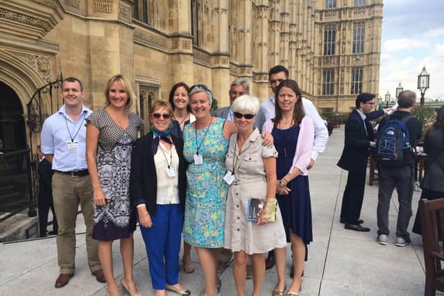Anna Wardley with Dame Caroline Dinenage MP with Anna's Five Island Swim Challenge support team at Westminster following non-stop swim around the Isle of Wight in 2013.