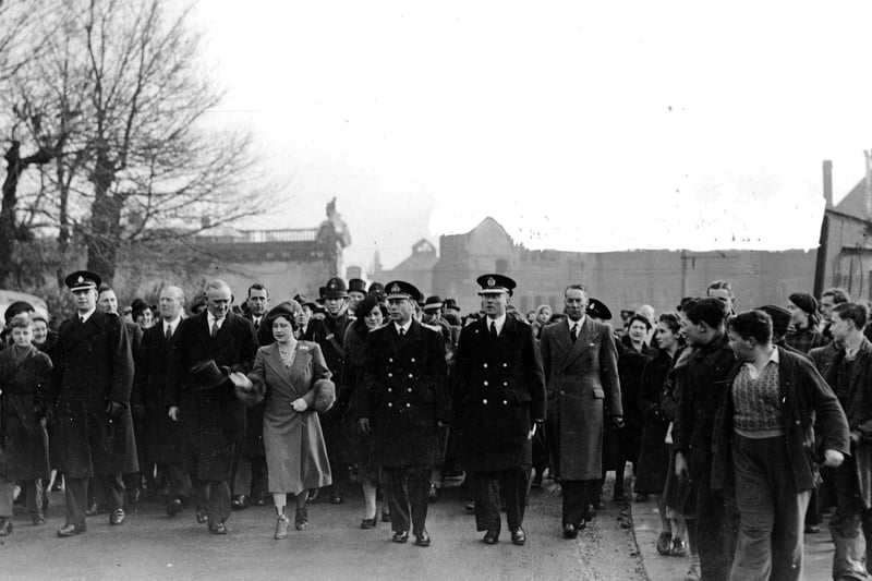 Being followed by crowds of adoring onlookers King George VI and Queen Elizabeth visit the city in 1941.
