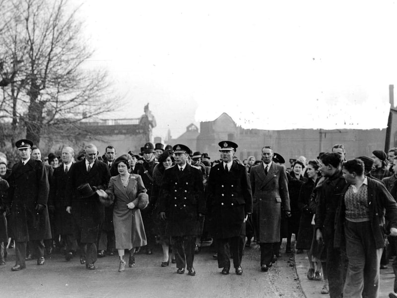Being followed by crowds of adoring onlookers King George VI and Queen Elizabeth visit the city in 1941.