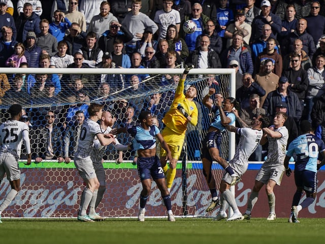 Pompey keeper Will Norris punches the ball clear in front of the Pompey fans in the away end at Adams Park
