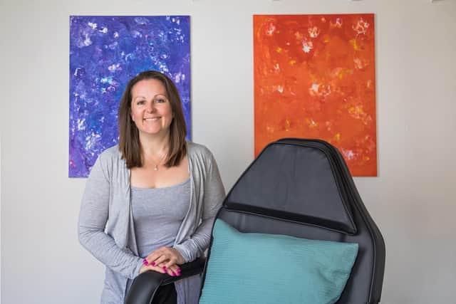 Sarah-Jane Lewis in her treatment room, decorated with artwork created with her children. Picture: Mike Cooter (100521)