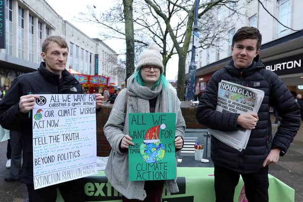Members of Extinction Rebellion - from left, Chris Price, Selma Heimedinger and Nathan Widdowson during a protest in Commercial Road, Portsmouth. 
Picture: Chris Moorhouse     (211219-26)