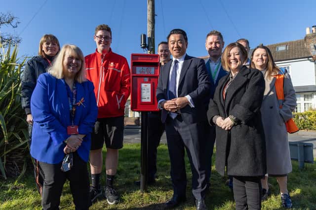 Alan Mak MP (centre) with Royal Mail Chief Executive Emma Gilthorpe (left) and Royal Mail staff at the new Stoke post box on Hayling Island