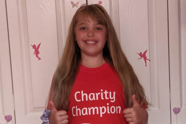 Grace McElhinney wearing her Wave 105 charity champion t-shirt