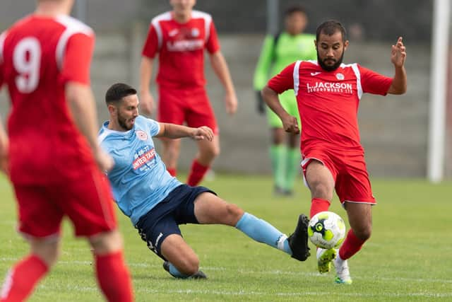 Former Southampton midfielder Jake Thompson, right, made his league debut for Horndean as a second half sub against Poppies. Picture: Keith Woodland