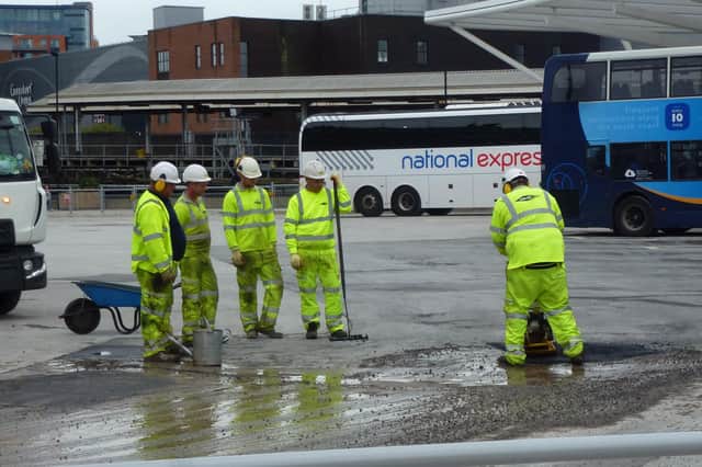 Workers sorting a temporary fix in October 2019 for the tarmac at the £9.2m Hard Interchange at Portsea. Portsmouth City Council is replacing the entire bus apron because it keeps failing. The authority is in legal discussions with its designer and contractor. Picture: Terry Pearson