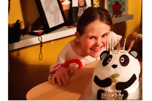 Enola with her panda-themed birthday cake