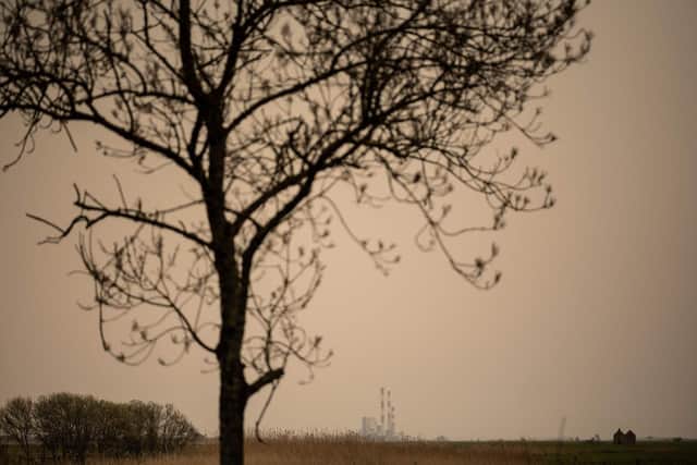 This photograph taken on March 15, 2022 shows the powerplant of French company EDF in Lavau-sur-Loire, western France, under a yellow ochre sky caused by Saharan dust. Picture: Loic Venance AFP via Getty Images)