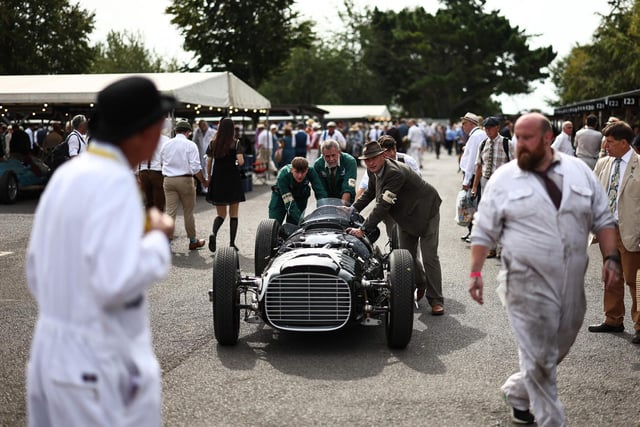 Mechanics prepare classic cars before a race on the opening day of Goodwood Revival at the Goodwood Motor Circuit in Chichester on September 8, 2023. The only historic motor race meeting to be staged entirely in a period theme, Goodwood Revival is an immersive celebration of iconic cars and fashion.
(Photo by HENRY NICHOLLS/AFP via Getty Images)
