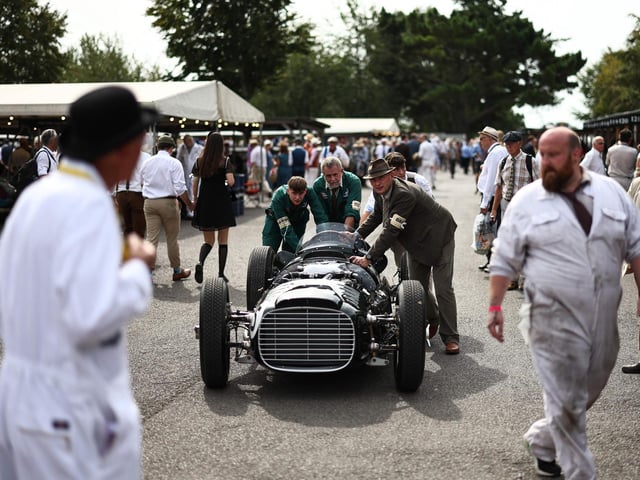 Mechanics prepare classic cars before a race on the opening day of Goodwood Revival at the Goodwood Motor Circuit in Chichester on September 8, 2023. The only historic motor race meeting to be staged entirely in a period theme, Goodwood Revival is an immersive celebration of iconic cars and fashion. 

(Photo by HENRY NICHOLLS/AFP via Getty Images)