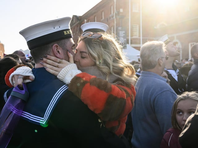 Leading Hand Fraser Gray is greeted by his partner Laura Krusinskyte following the arrival of the United Kingdom's biggest warship, the HMS Prince of Wales aircraft carrier, following a three months deployment, on December 11, 2023. Picture: Leon Neal/Getty Images.