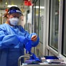 A nurse puts on PPE in a ward for Covid patients at King's College Hospital, in south east London.