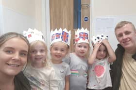 Children and staff from Tops Day Nurseries making the Queen's crown.