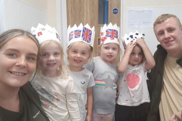 Children and staff from Tops Day Nurseries making the Queen's crown.