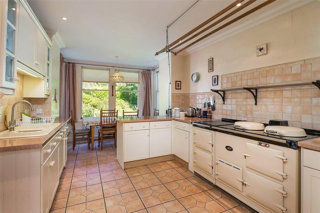 The bright kitchen has an Aga and space for dining.