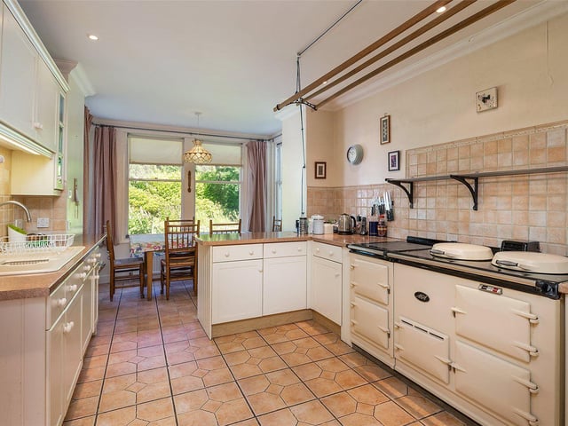 The bright kitchen has an Aga and space for dining.