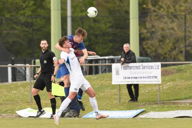 USP sub Sonny Harnett-Balkwill rises above Binfield skipper Sean Moore. Picture: Keith Woodland