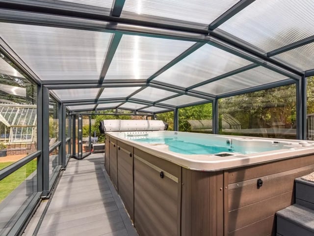 This property comes with five bedrooms,  four bathrooms and two reception rooms as well as a large garden and a swimming pool.