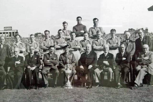 Pompey pose with the Division One trophy.