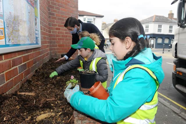 Year 2 pupils from Bramble Infant School and Nursery in Southsea, planted flowers outside the Co-op in Fawcett Road, Southsea, on Tuesday, March 23, as part of the Wilder Portsmouth scheme.

Pictured is: (front) Zeynep Yalcin (6).

Picture: Sarah Standing (230321-5343)