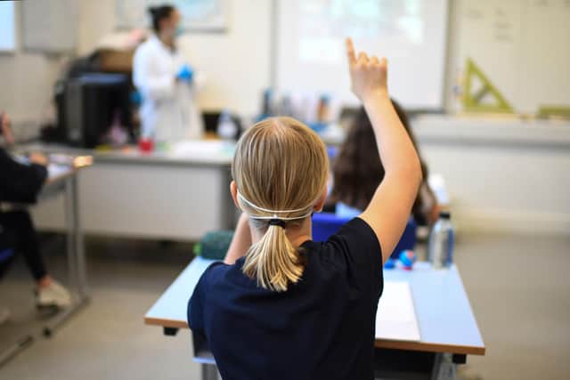A Year 6 pupil wearing a face mask raises a hand to ask a question in a classroom at the College Francais Bilingue De Londres French-English bilingual school in north London on June 2, 2020. Picture: DANIEL LEAL-OLIVAS/AFP via Getty Images