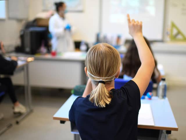 A Year 6 pupil wearing a face mask raises a hand to ask a question in a classroom at the College Francais Bilingue De Londres French-English bilingual school in north London on June 2, 2020. Picture: DANIEL LEAL-OLIVAS/AFP via Getty Images