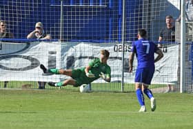 Roux Hardcastle saves a penalty against Horndean in the FA Cup last August - he saved two more spot-kicks as Baffins beat Lymington to progress to the quarter-finals of the Hampshire Senior Cup. Picture: Neil Marshall