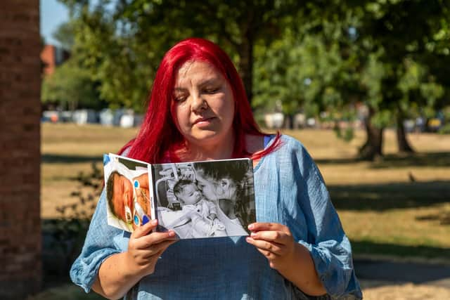 Katie Keeling (37) with the photo book containing images of her son Harrison. Picture: Mike Cooter (130822)