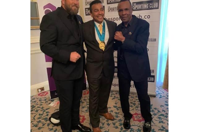 Q Shillingford MBE receiving the WBC medal, alongside retired professional boxer Scott Welch, and 'Sugar' Ray Leonard.