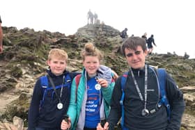 From left, Charlie (12), Connie (15) and Jack (14) Threadingham with their Three Peaks Challenge medals.