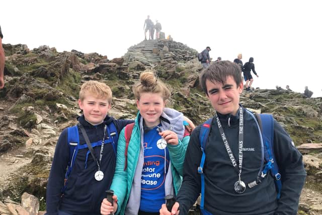 From left, Charlie (12), Connie (15) and Jack (14) Threadingham with their Three Peaks Challenge medals.