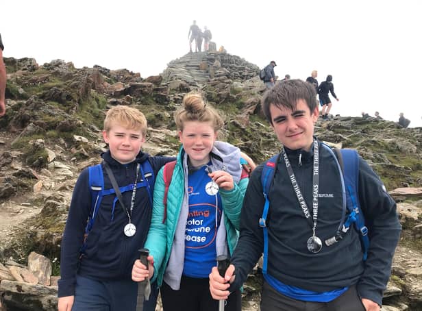 From left, Charlie (12), Connie (15) and Jack (14) Threadingham with their Three Peaks Challenge medals.