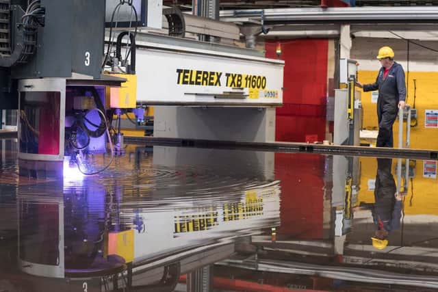 Steelcutter Alex Clark operating the laser cutter on the last section of Glasgow. 
Photo: John Linton Photography