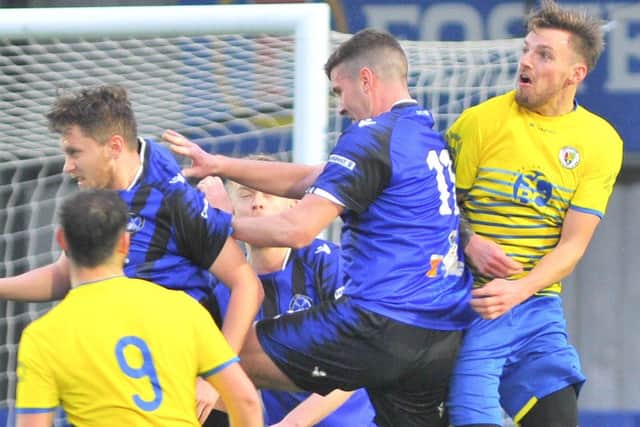 Players from Clanfield (blue/black) and Locks Heath challenge at a set piece. Picture: Martyn White