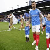 Pompey captain Marlon Pack with two young Blues mascots coming out onto the Fratton Park pitch ahead of the game against Wycombe last season