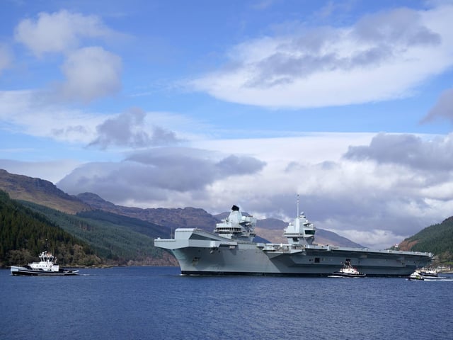 The Royal Navy aircraft carrier HMS Queen Elizabeth leaving Glen Mallan in Loch Long with the Arrochar Alps behind. Photo: Andrew Milligan/PA Wire