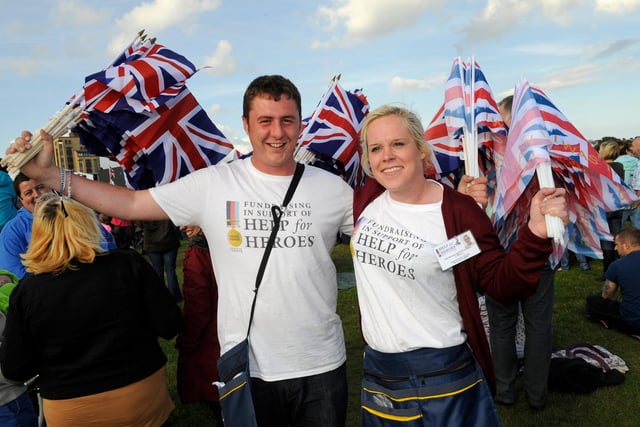 The Evening Celebrations at The Olympic Torch Relay as it came to Southsea Common early on Sunday evening 
There were stage acts as well as Rizzle Kicks a pop duo,  as 65000 people enjoyed the free spectacle 
Flag sellers ! - (left to right) Jack Hughes (20) and Claire Wallace (27) both from Dundee in Scotland 
Picture: Malcolm Wells (122387-1142)
