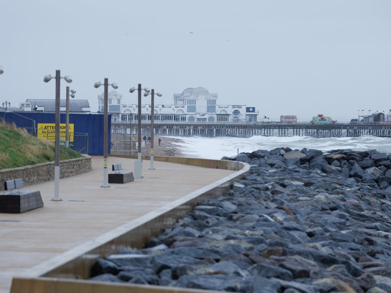 A moody sea crashed waves high onto footpaths as passer-by's did their best to get out the way