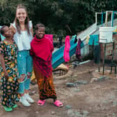 Hope Prosser with two sisters the charity has helped support at the orphanage