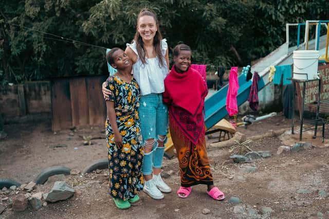 Hope Prosser with two sisters the charity has helped support at the orphanage