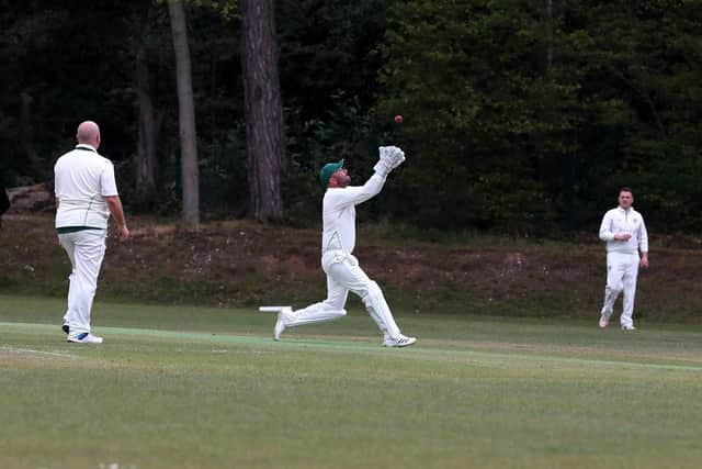 Sarisbury Athletic wicket-keeper Simon Orr about to take a catch in his side's Village Cup KO win against Hambledon. Picture: Sam Stephenson