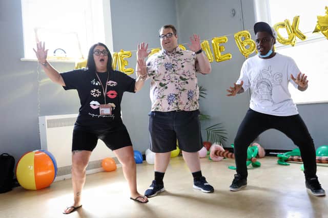 From left, support worker Nicola Simmons, Chris O'Carroll and Rhinel Djemo working on their dance moves. Pathways Support for adults with learning disabilities has reopened at Fratton Community CentrePicture: Chris Moorhouse (jpns 290721-28)