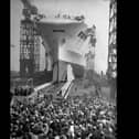 Crowds watch as the 22,000 ton aircraft carrier HMS Ark Royal (91) is launched at the Cammell Laird shipyard in Birkenhead, 13th April 1937. The ship was later sunk off Gibraltar by the German submarine U-81 in November 1941. (Photo by Hudson opical Press Agency/Hulton Archive/Getty Images)