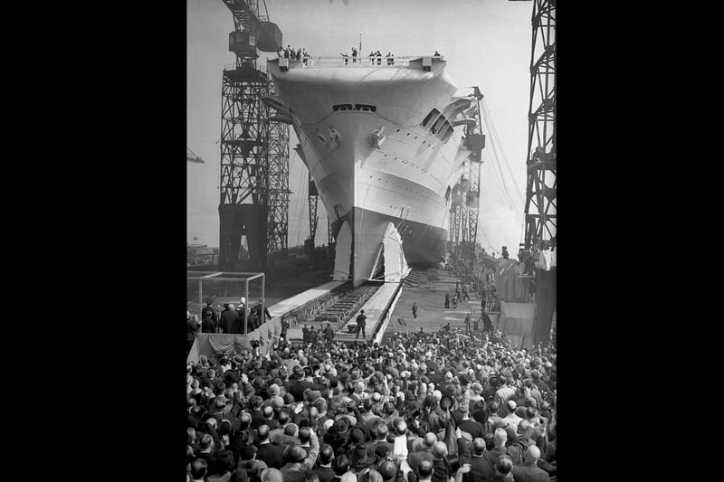 Crowds watch as the 22,000 ton aircraft carrier HMS Ark Royal (91) is launched at the Cammell Laird shipyard in Birkenhead, 13th April 1937. The ship was later sunk off Gibraltar by the German submarine U-81 in November 1941. (Photo by Hudson opical Press Agency/Hulton Archive/Getty Images)
