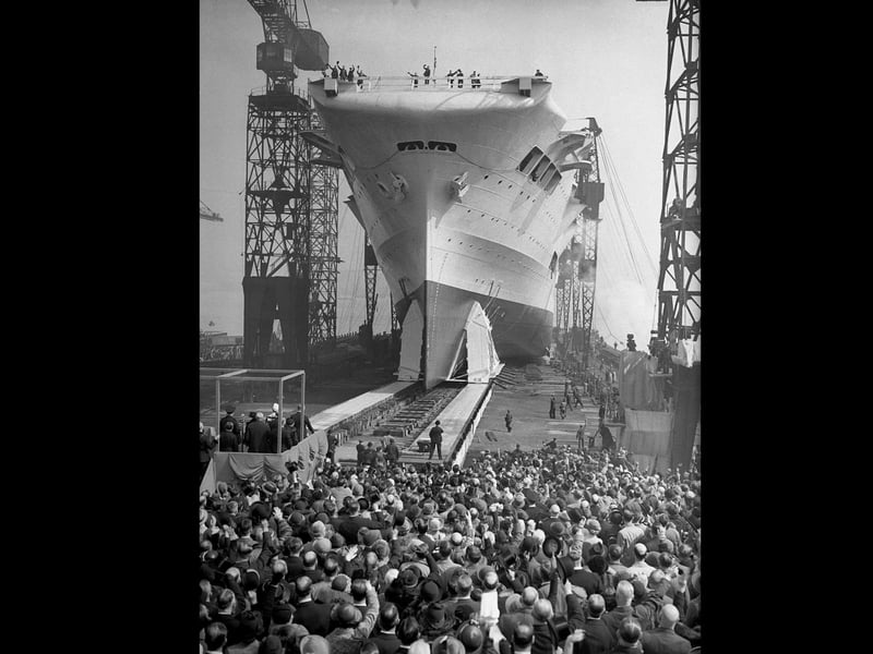 Crowds watch as the 22,000 ton aircraft carrier HMS Ark Royal (91) is launched at the Cammell Laird shipyard in Birkenhead, 13th April 1937. The ship was later sunk off Gibraltar by the German submarine U-81 in November 1941. (Photo by Hudson opical Press Agency/Hulton Archive/Getty Images)