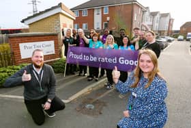 Home Manager Aimee Sparks with Deputy Manager Adrian Ballinger (crouching) celebrating the award with the team at Pear Tree Court.