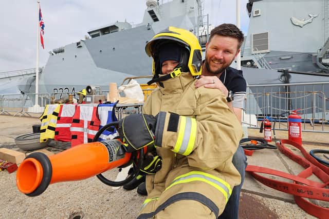 A young lad tries his hand at firefighting during the families day on HMS Spey. Photo: LPhot Lee Blease